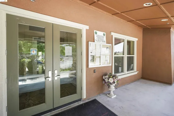 Doorway to property with french doors and stucco siding
