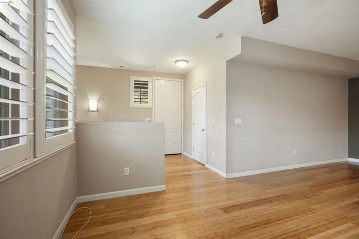 Empty room featuring light wood-style floors and a ceiling fan