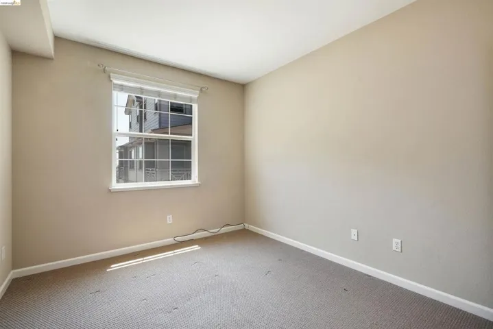 Carpeted empty room with baseboards
