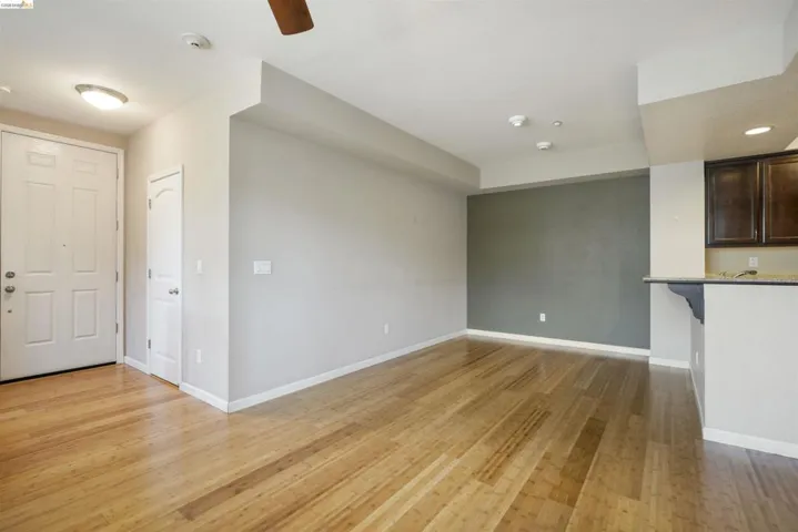 Unfurnished living room featuring light wood-style floors, ceiling fan, and recessed lighting