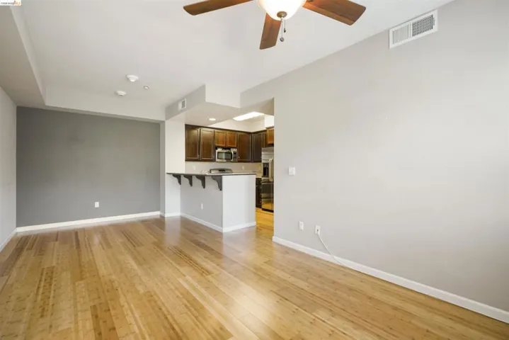 Unfurnished living room featuring ceiling fan and light wood finished floors