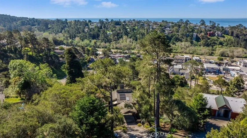 View of house from drone showing proximity to downtown and ocean.
