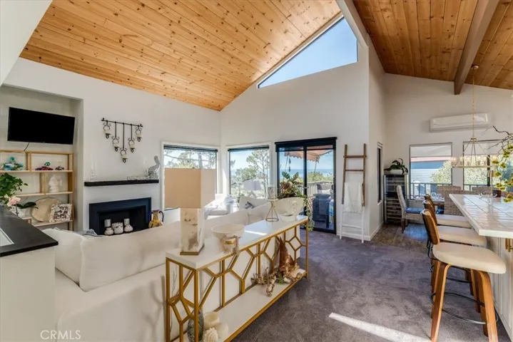 View of living room, deck and kitchen counter.
