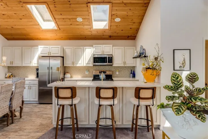 Breakfast bar, kitchen and peek of dining area.
