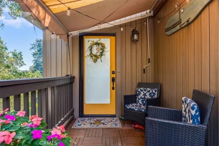Front door to house and showing front deck.