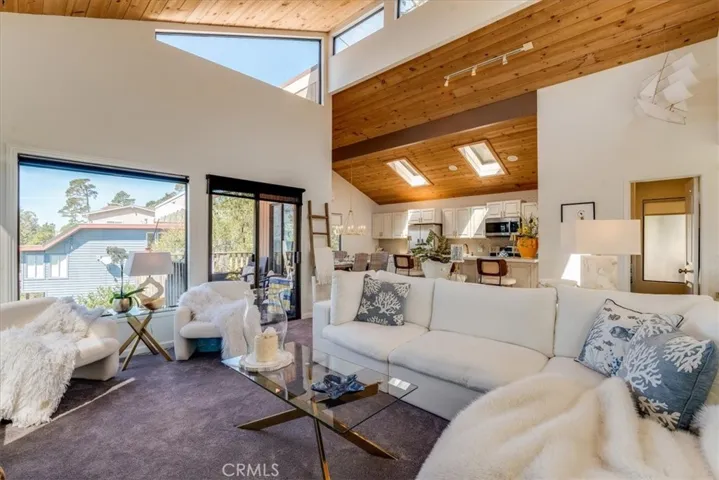 Another angle of of top floor showing living room, half bath, kitchen and dining area.