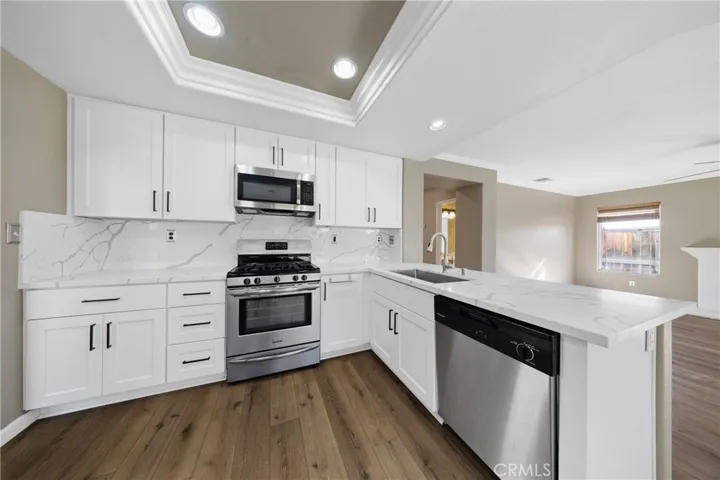 Stylish Kitchen Featuring Modern Finishes, Ample Cabinetry, And Recessed Lighting
