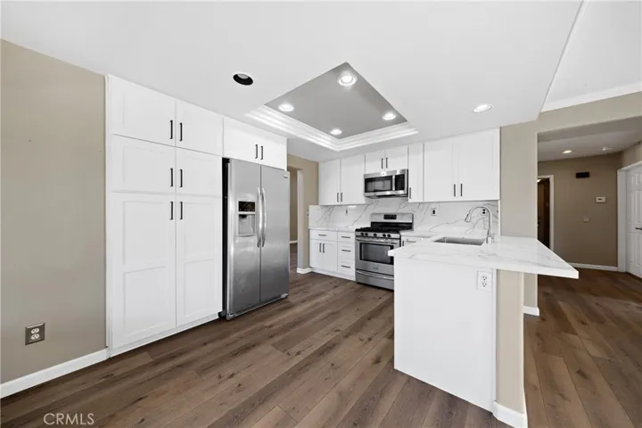 Updated Kitchen With Stainless Steel Appliances And Breakfast Bar