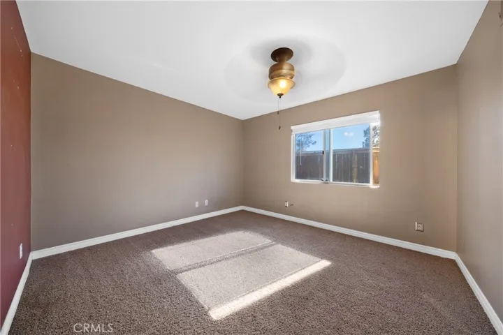 Downstairs Bedroom With Plush Carpet And Natural Light