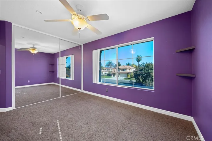 Bright Bedroom Featuring Custom Paint And Ample Natural Light