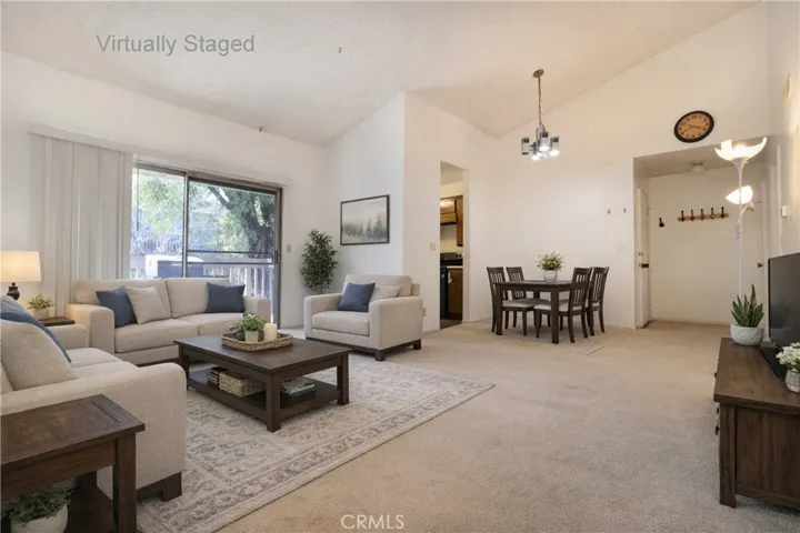 Living Room & Dine Area view to balcony Virtually Staged