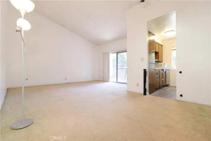 Living Room & Dine Area view to balcony and Kitchen