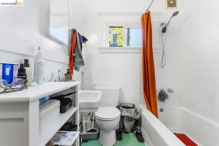 Bathroom featuring toilet and shower / bath combo