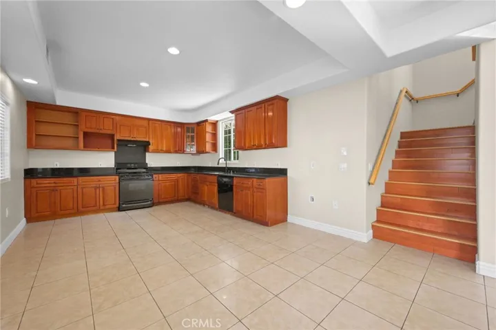 Wood cabinets with black granite counters.