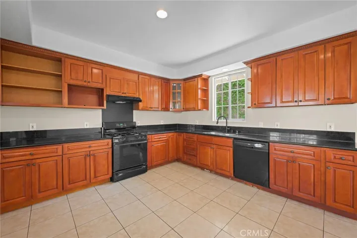 Gas stove, some open display shelves.