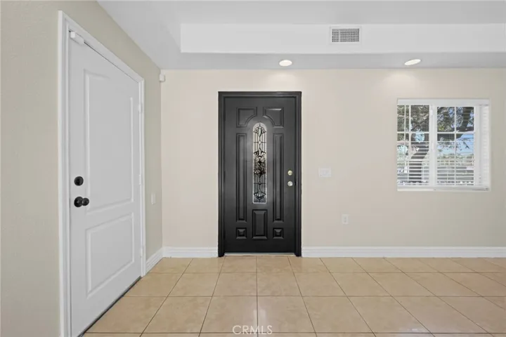 White door leads to the attached 2 car garage.