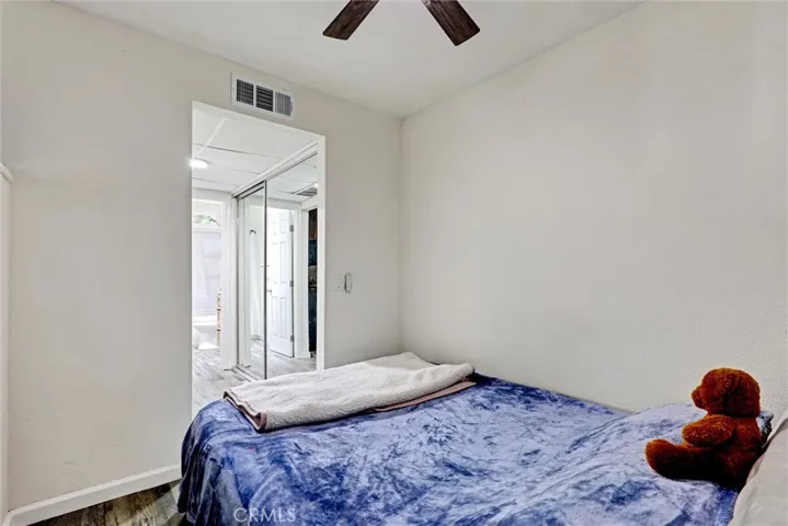Bedroom with view of dressing and storage area