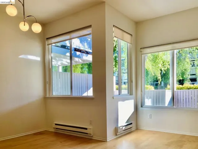 Doorway to outside featuring a baseboard radiator and wood finished floors