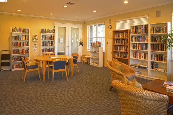 Dining room featuring french doors, ornamental molding, recessed lighting, and dark carpet