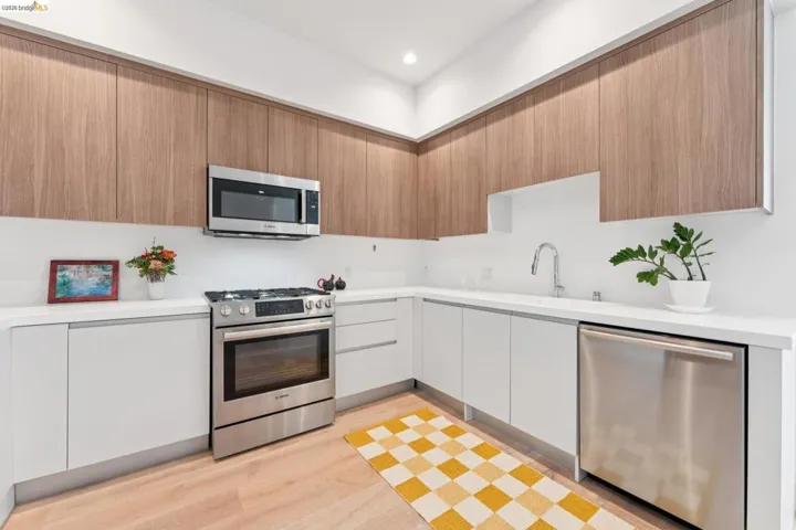 Kitchen featuring stainless steel appliances, modern cabinets, light wood-style floors, and recessed lighting