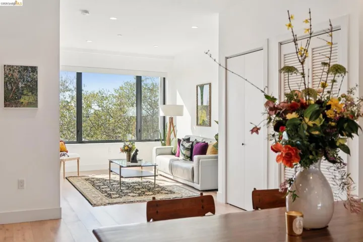 Living area with light wood-type flooring and recessed lighting