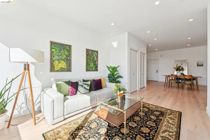 Living area featuring light wood-style floors and recessed lighting