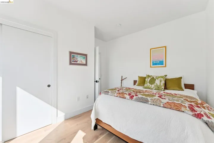 Bedroom with light wood finished floors and a closet