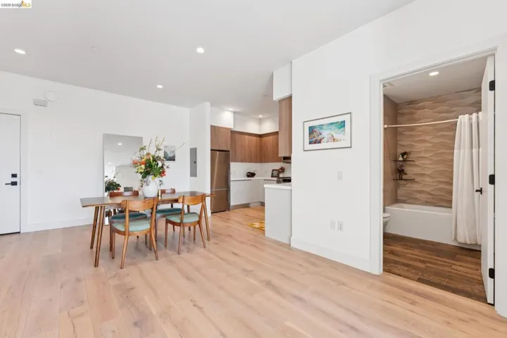 Dining room featuring light wood-type flooring, recessed lighting, and electric panel