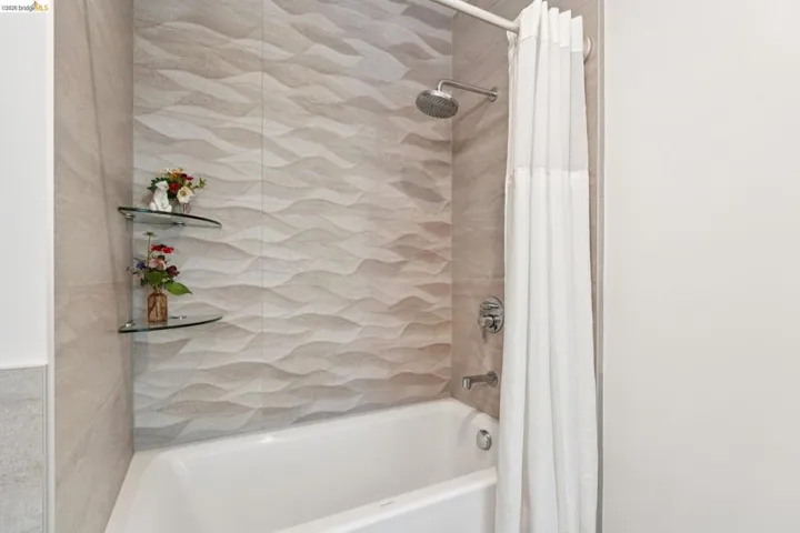 Full bath featuring shower / bath combination with curtain