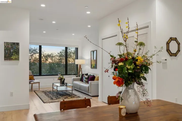 Living room with light wood finished floors and recessed lighting