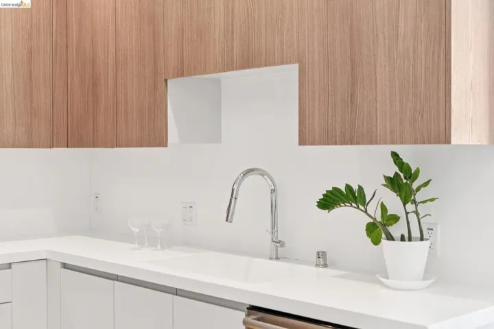 Kitchen featuring modern cabinets and white cabinetry
