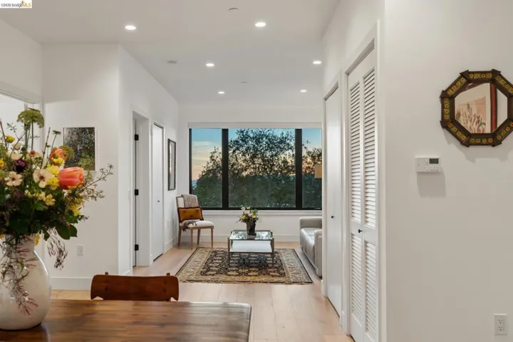 Hall with light wood-type flooring and recessed lighting