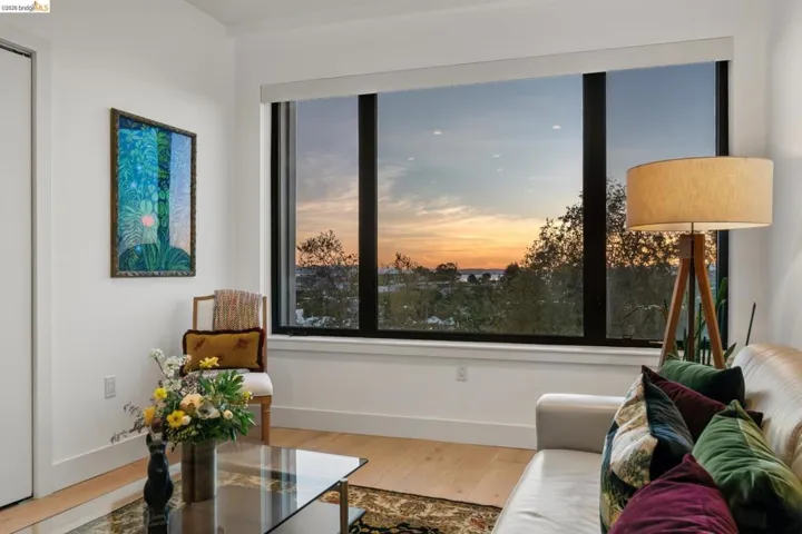 Living area with baseboards and light wood-type flooring