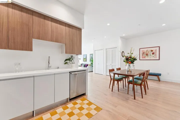 Kitchen featuring dishwasher, recessed lighting, modern cabinets, and light wood finished floors