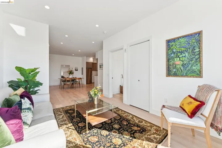 Living area with light wood-style floors and recessed lighting