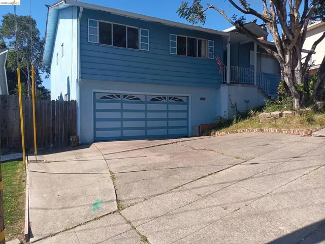 View of front of home with a garage and concrete driveway