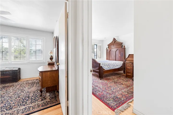 View from Upstairs hallway into two generously sized front bedrooms with large windows