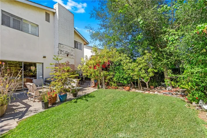 View home from back yard, top right window is the Master