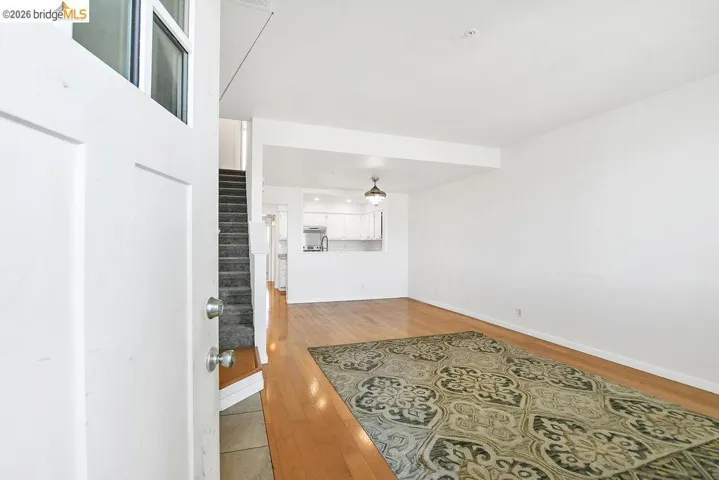 Living room featuring light wood finished floors and stairway