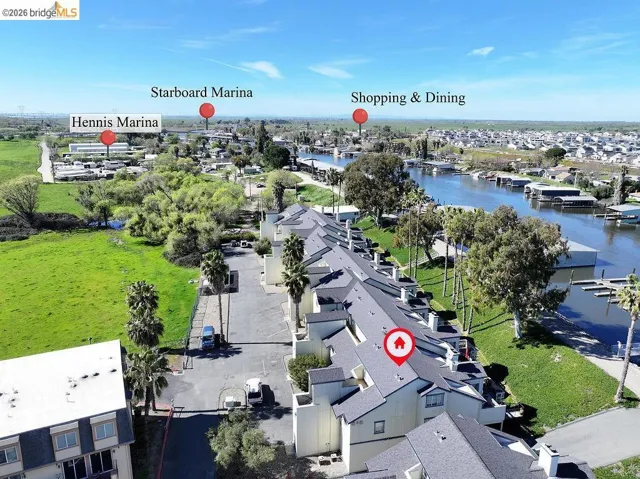 Aerial perspective of suburban area featuring a large body of water