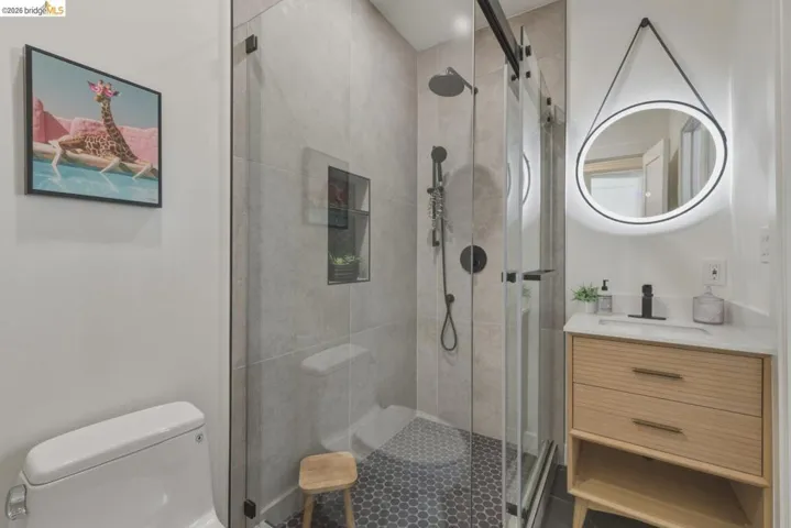Bathroom featuring vanity and a shower stall