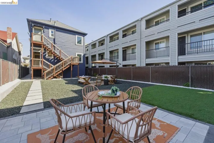 Fenced backyard featuring outdoor dining space and a patio area