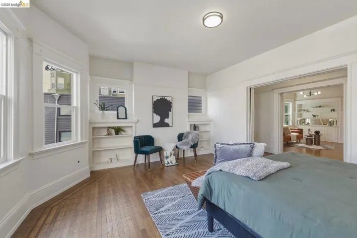 Bedroom featuring dark wood finished floors and baseboards