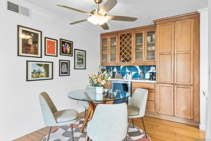 Dry bar, pantry cabinet with pullout drawers, and wine refrigerator