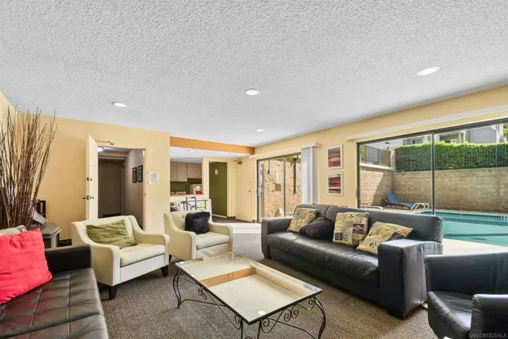Recreation room with kitchen and sliding doors to the pool area