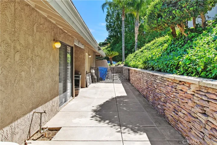 This is the side yard which has the sliding door access from the dining room. The gate leads to the front driveway.