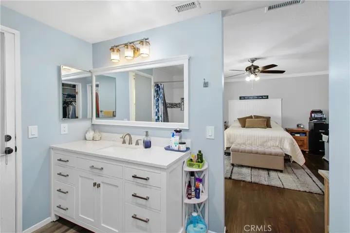 The primary bath features an updated vanity, it also has a door to the back patio.