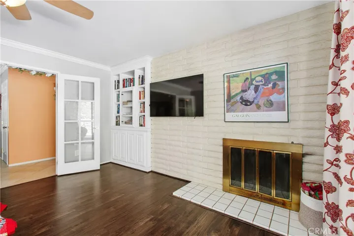 There is also a built-in bookcase cabinet on the fireplace wall.