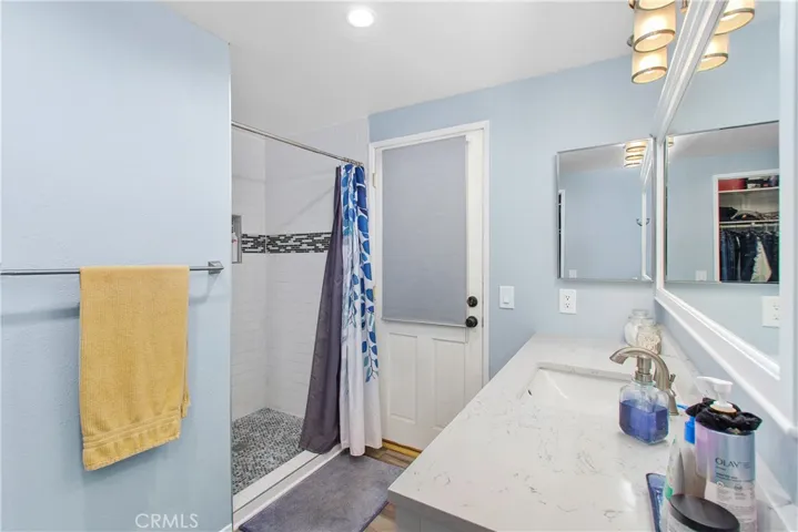 The shower has been updated with custom tile from floor to ceiling.