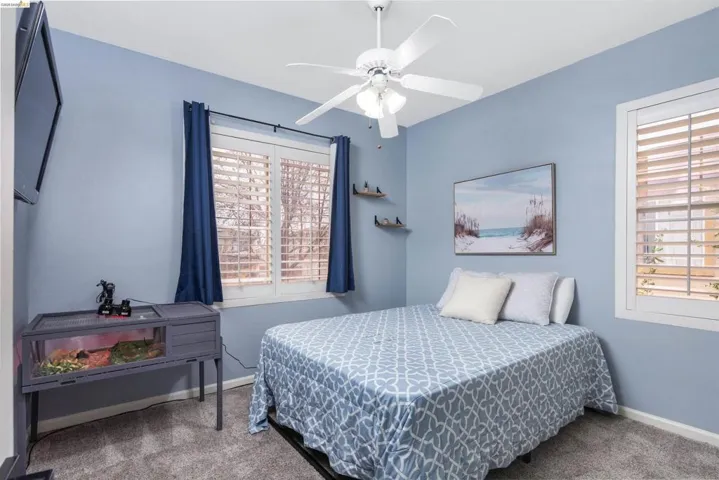 Bedroom with carpet floors and a ceiling fan